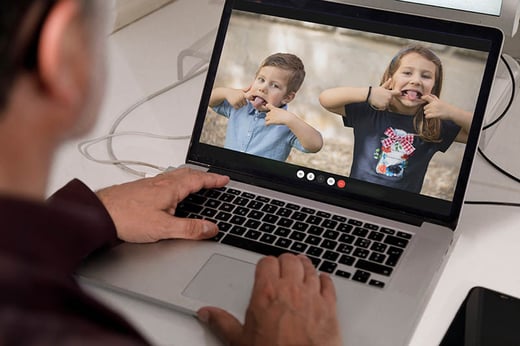 children on a video call pulling faces to their relative