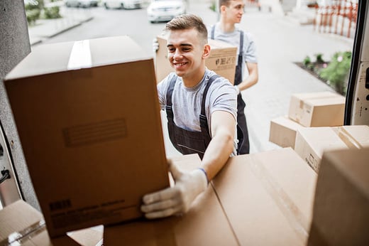 man loading removals boxes into van