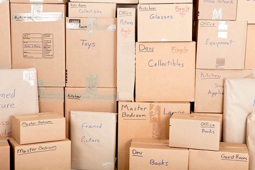 stack of moving boxes with labels of whats inside